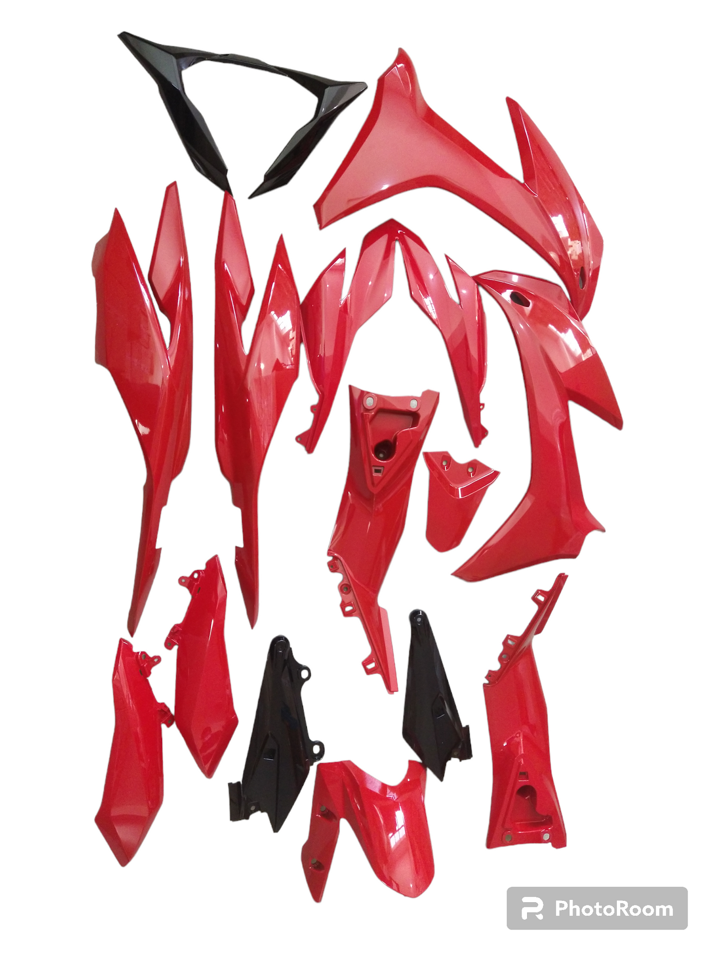 A set of red motorcycle covers and parts laid out on a white background.
